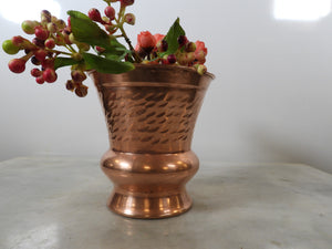 Hand-hammered polished copper vase with a textured surface and flared rim