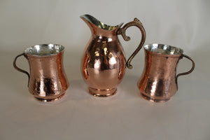A Copper Creamer and Hand Hammered Copper Mugs